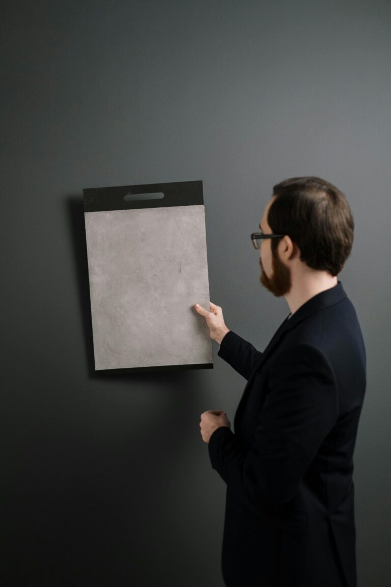 Architect examining a wall material sample for interior design project.
